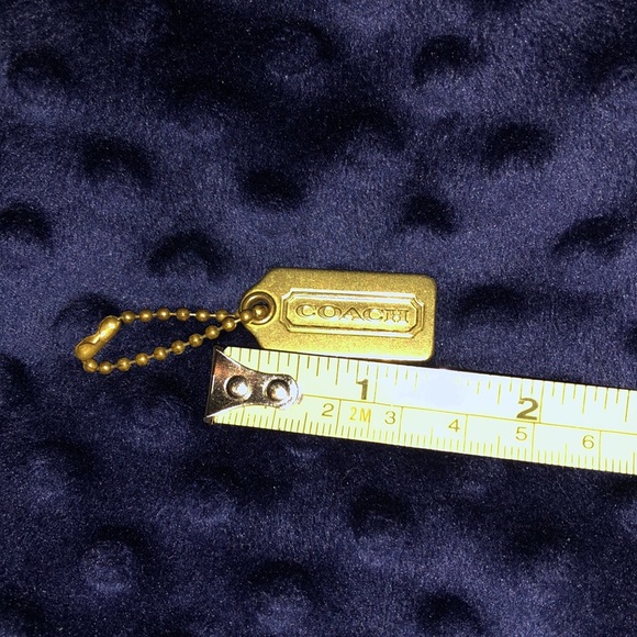 Another Coach charm! All metal logo on front, small on back, gold Preowned EUC